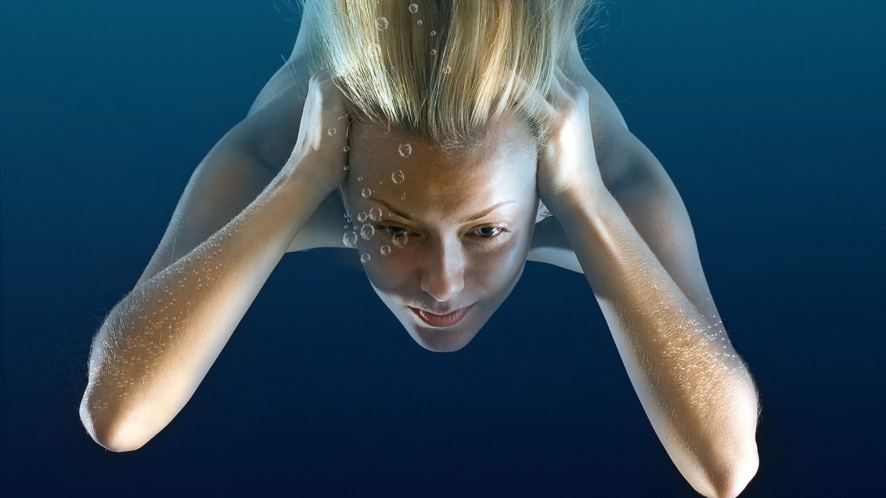 Girl Under Water Immersing Blonde Bubbles