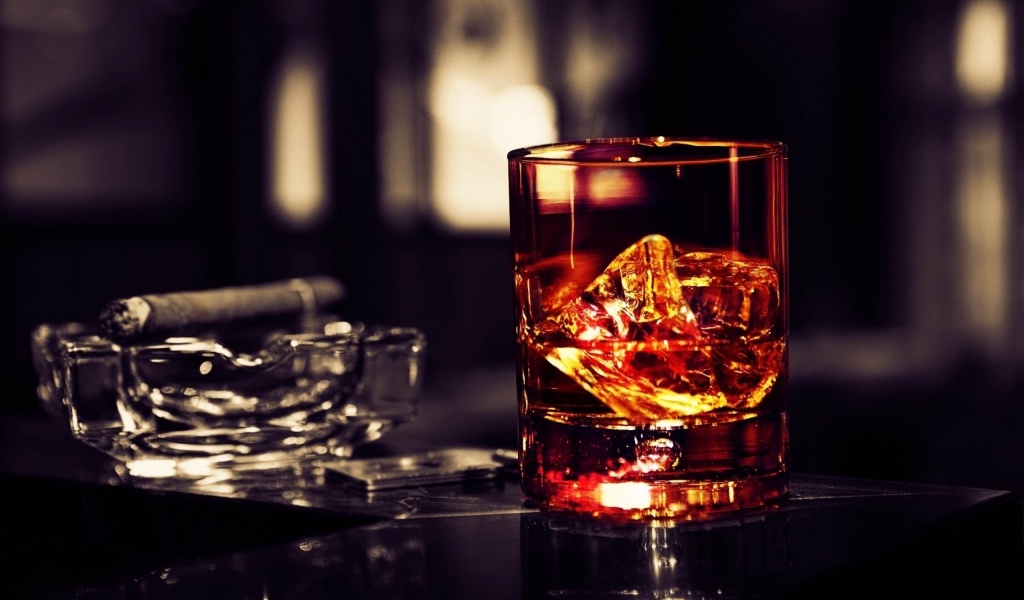 Whisky Glass With Cigar On The Table